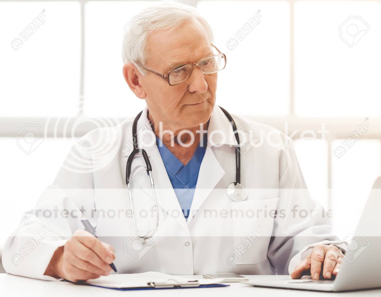  photo 65186969-handsome-old-doctor-in-white-medical-coat-and-eyeglasses-is-using-a-laptop-making-notes-and-smiling-_zpsjq3zyvuu.jpg