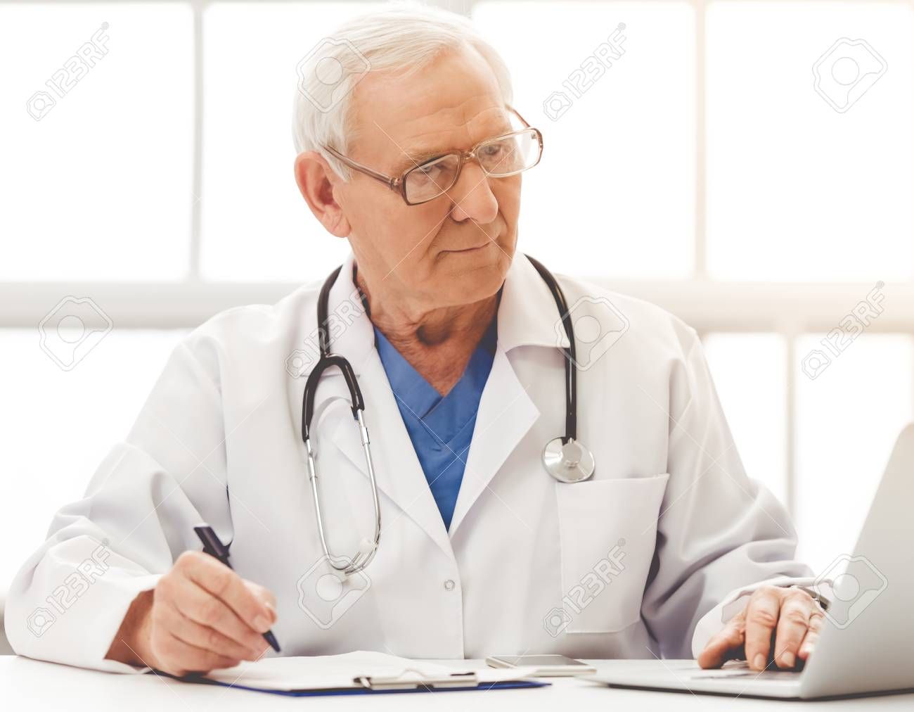  photo 65186969-handsome-old-doctor-in-white-medical-coat-and-eyeglasses-is-using-a-laptop-making-notes-and-smiling-_zpsjq3zyvuu.jpg